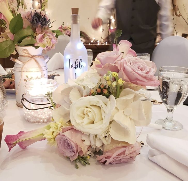 white and lavender floral centerpiece for wedding reception