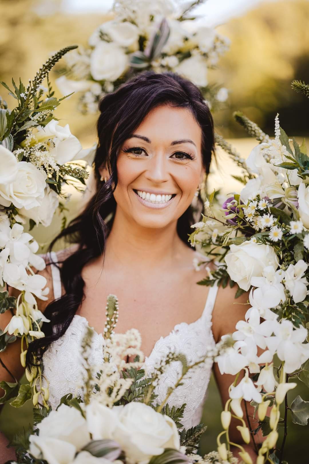 bride surrounded by white bouquets