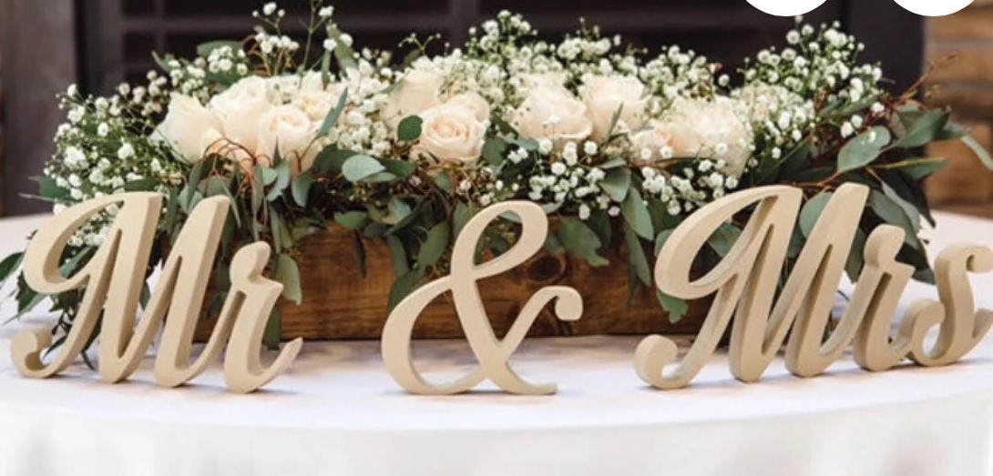 Mr. and Mrs. sign with white rose floral centerpiece in wooden container