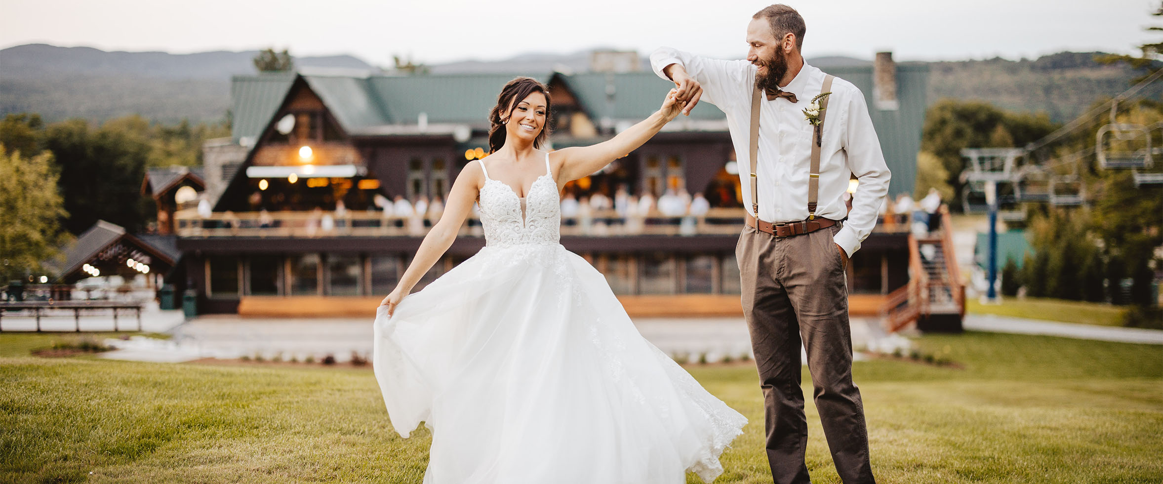 groom twirling bride outside ski resort venue