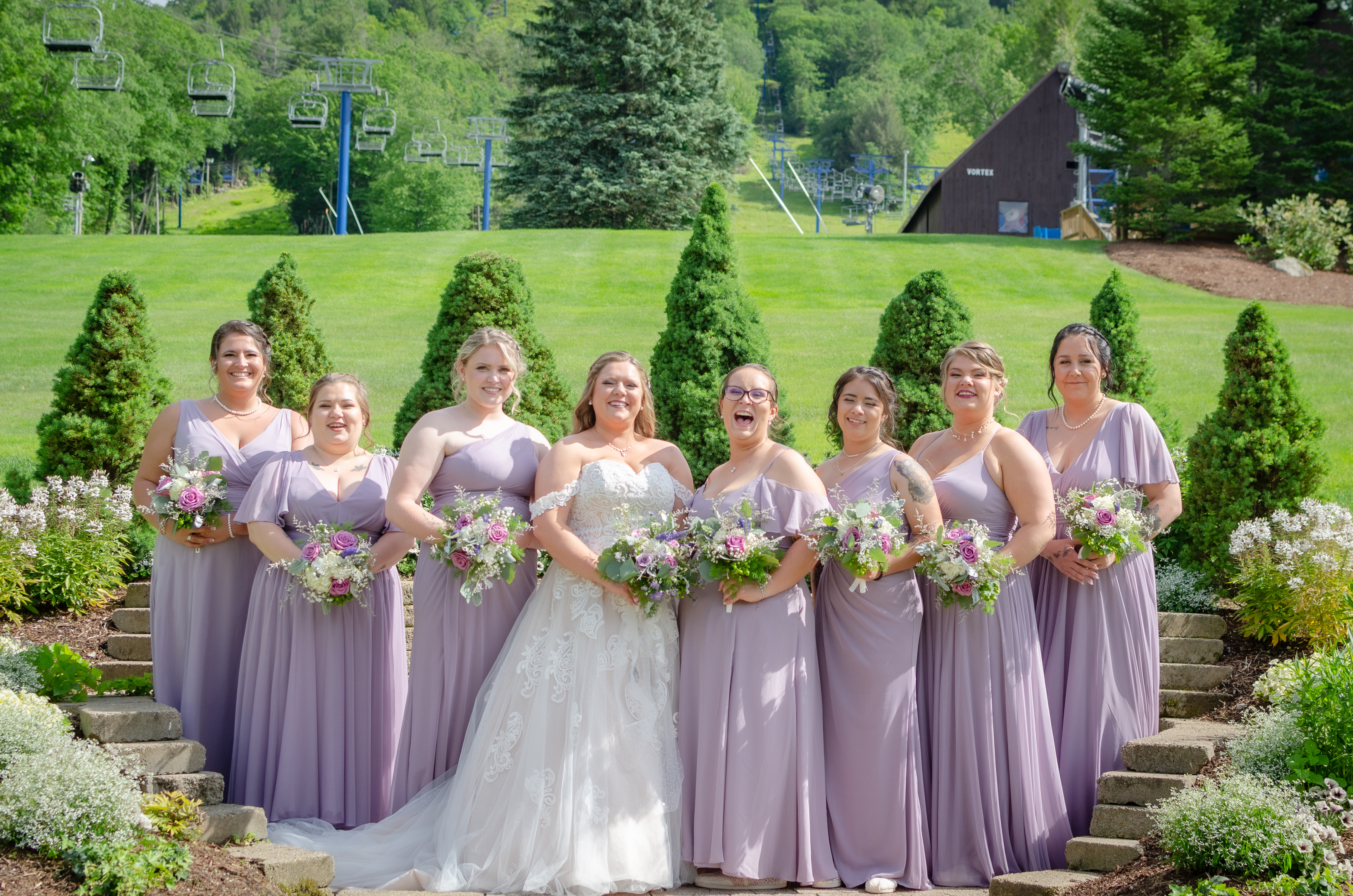 bride and bridesmaids in lavender gowns at ski lodge