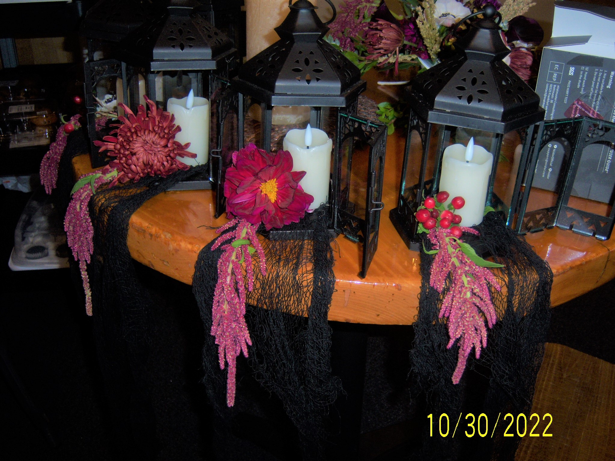 black candle centerpieces with red flowers